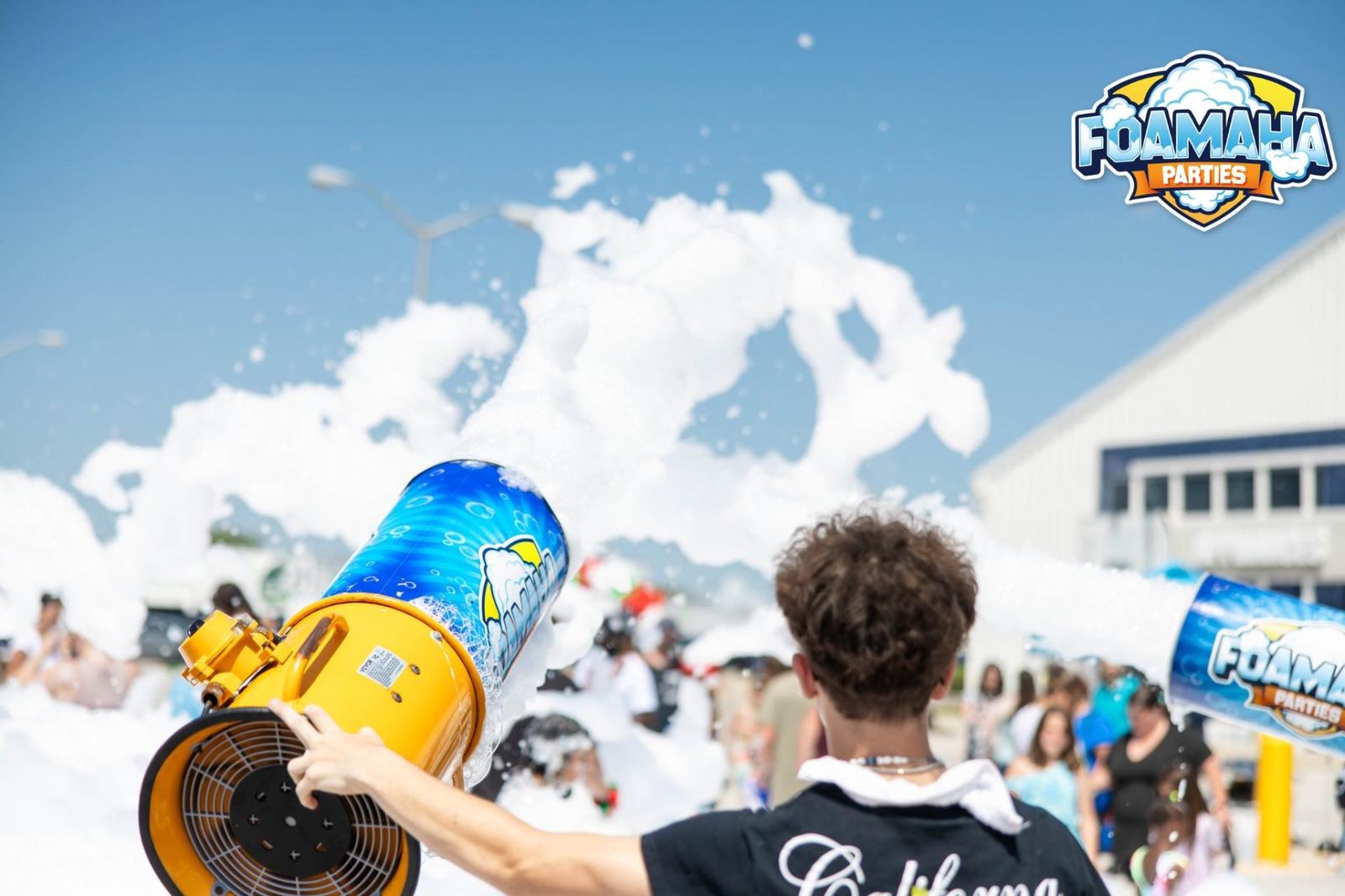 A Foamaha foam cannon firing foam over an outdoor party